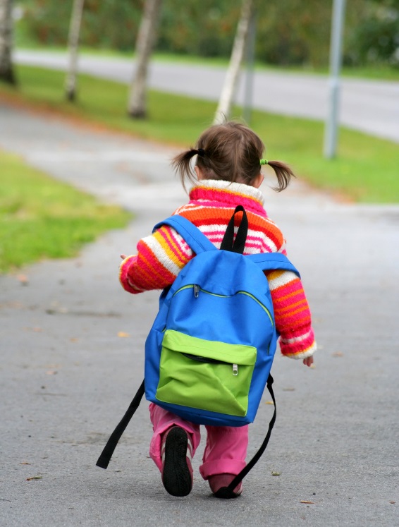 Child walking with book bag